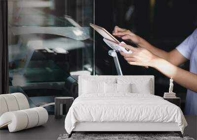 Close-up of hand young asian woman use digital tablet to receive orders from customers Wall mural