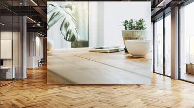 Closeup white cup of coffee with small trees and green leaf in vase on wooden table Wall mural