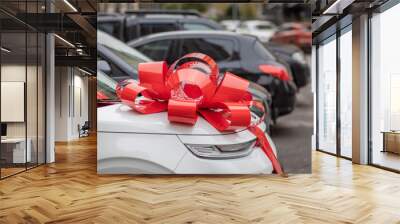 a white car with a big, red bow on the hood is on the street, an expensive gift, a new car as a gift, a gift car Wall mural