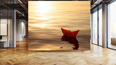 origami paper boat floats on water at sunset, travel and adventure concept Wall mural