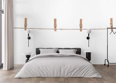 wooden clothespins on a rope on a white background isolate Wall mural