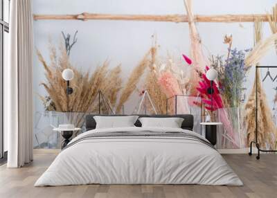 Bouquets of natural dried plants of dried flowers that retain their shape and bright colors in glass vases for the art of making flower compositions. Wall mural