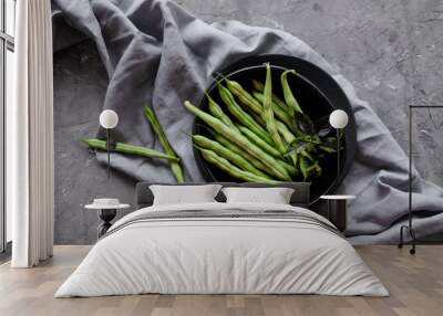 Black bowl with fresh green string beans on gray cement backgound Wall mural