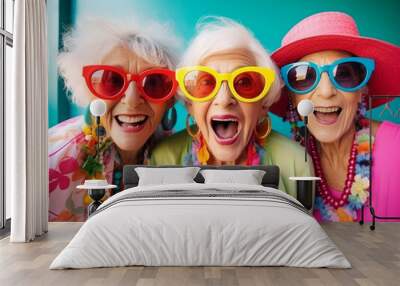 Happy and funny cool old three ladies wearing fashionable bright clothes. Happy and modern Senior women.  Wall mural