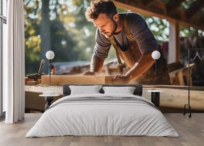 Portrait of young male carpenter work in the wood workshop Wall mural