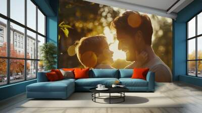 A father tenderly holds his daughter in his arms Wall mural