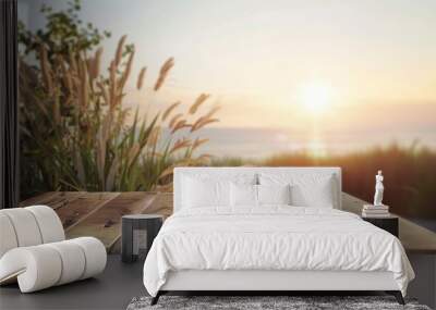 A wooden table top with a blurred sunset beach background Wall mural