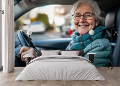 An elderly woman enjoys a moment of bliss behind the wheel, smiling brightly Wall mural