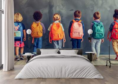 Group of children standing indoors with backpacks. Back to school concept. Wall mural