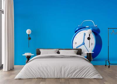 Blue alarm clock isolated on blue background with retro style. Classic analog clock and blank space. 3D rendering. Wall mural