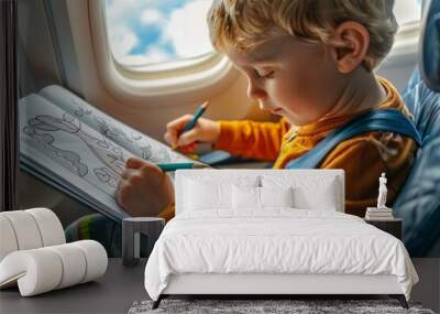 A child is coloring on an airplane, staying entertained with this inflight activity Wall mural