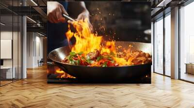 a person mixing food in a wok with flames Wall mural