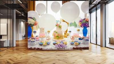 Candy bar on golden wedding party with a lot of different candies, cupcakes, souffle and cakes. Decorated in brown and purple colors, nature and eco theme, indoor Wall mural