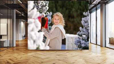 Smiling blonde curly girl with letter near the Santa's mailbox Wall mural