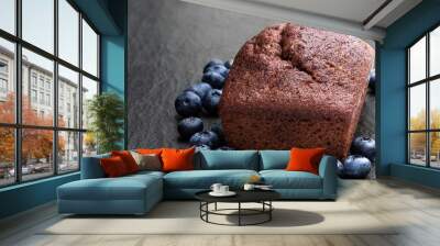 Freshly baked chocolate and blueberry bread on black stone background Wall mural