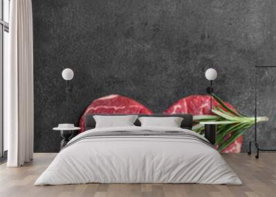 Heart shape raw fresh beef steak with rosemary stick on metal background Wall mural