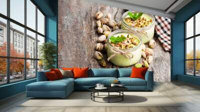 Natural  pistachio yogurt in a small glass jar on wooden table Wall mural