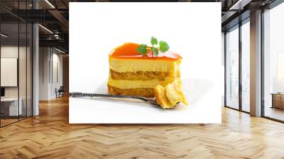 Slice of layered mango cheesecake isolated on white Wall mural