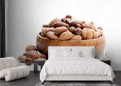 Various  nuts in wooden bowl isolated on white Wall mural