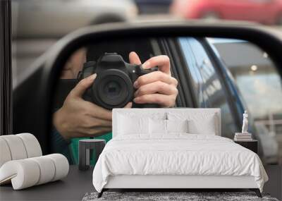 Hidden photographing. Reflection in car mirror of woman with camera. Paparazzi concept Wall mural