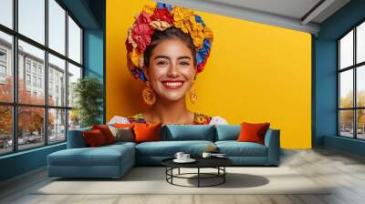 Studio portrait of a beautiful young hispanic woman wearing traditional clothing smiling on a yellow background Wall mural