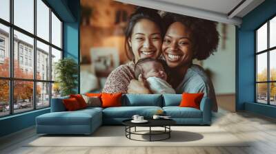 Two mothers are smiling while holding their newborn baby, enjoying a tender family moment in their home Wall mural