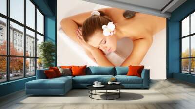 A beautiful woman relaxing in a spa center, isolated on white Wall mural