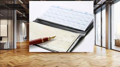 An open checkbook and a ballpen isolated on white Wall mural