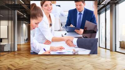 Business people shaking hands, finishing up a meeting Wall mural