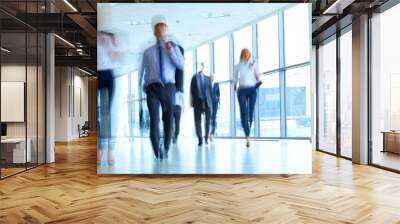 businesspeople walking in the corridor of an business center Wall mural