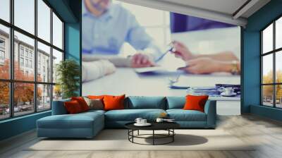 Close up of doctor and patient sitting at the desk near the window in hospital Wall mural