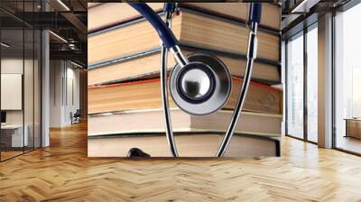 Concept of medical education with book and stethoscope Wall mural