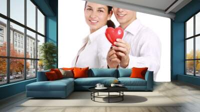 Couple holding a red heart, isolated on white background Wall mural