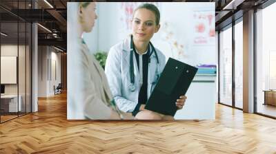 Doctor and patient discussing something while sitting at the table . Medicine and health care concept Wall mural