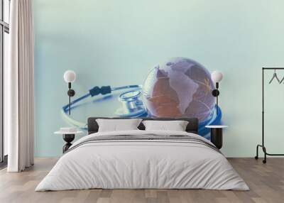 Globe and stethoscope, on the gray background Wall mural