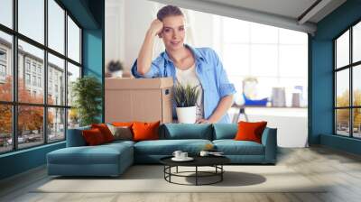 Portrait of a young woman with boxes Wall mural