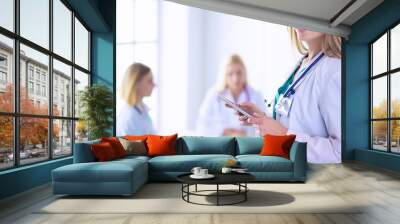 Woman doctor standing with stethoscope at hospital . Woman doctor Wall mural