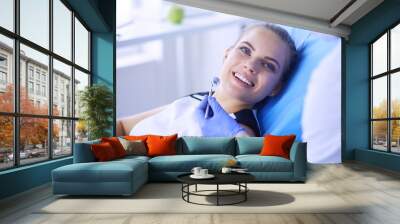 Young Female patient with pretty smile examining dental inspection at dentist office. Wall mural