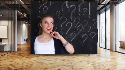 Young girl with question mark on a gray background Wall mural