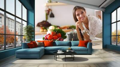 Young woman standing near desk in the kitchen Wall mural