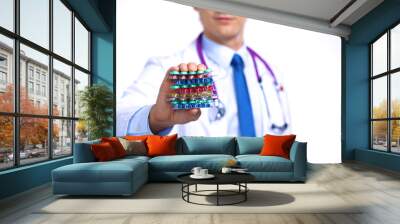 A young doctor holds the patient's hand with pills Wall mural