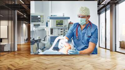 Several doctors surrounding patient on operation table during t Wall mural