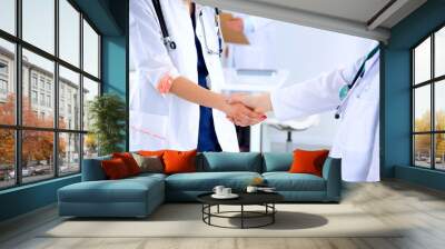 young medical people handshaking at office Wall mural