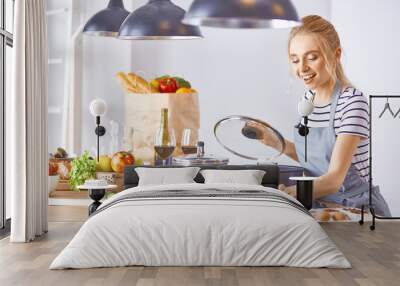 Young Woman Cooking in the kitchen. Healthy Food Wall mural