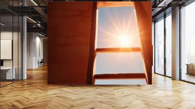 A ladder within an architectural frame leading up towards a bright light, representing aspiration and direction against a textured stone background. Wall mural