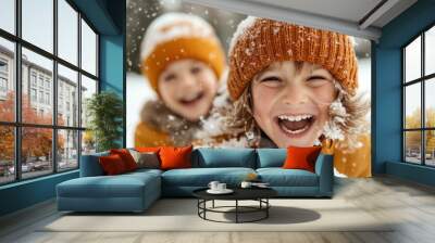 Two children, with bright smiles, are surrounded by gently falling snowflakes while outside, embodying the pure happiness and energy of a snowy day. Wall mural