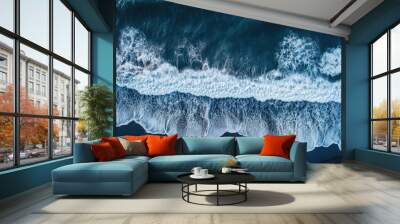 Aerial drone view or top view perspective photography of a beautiful transparent clear sea or ocean waves and foam splashing on the dark navvy blue or gray sand beach Wall mural