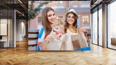 Two friends relaxing on a bench during shopping Wall mural