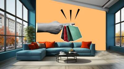 A human finger holding shopping bags Wall mural