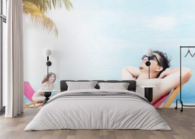 Asian people relaxing on the beach chair Wall mural